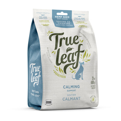 A package of True Leaf brand calming support chews for pets, with a picture of a dog and text detailing the product is hemp seed oil based and grain free.